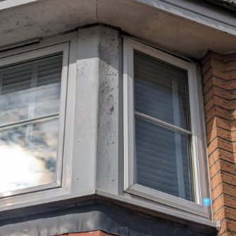 Bay window with dirty grey frames before